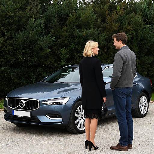 Charming Couple by a Gray Volvo