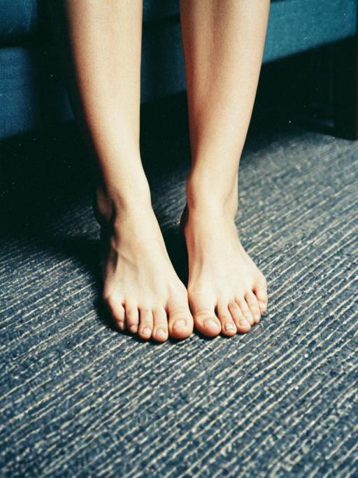 Close-up of Bare Feet on Carpet