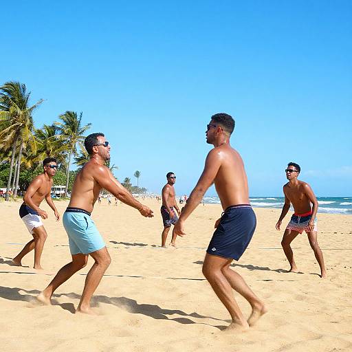 Photograph of five shirtless men playing beach ultimate frisbee on sunny, golden sand with clear blue sky and palm trees in background.