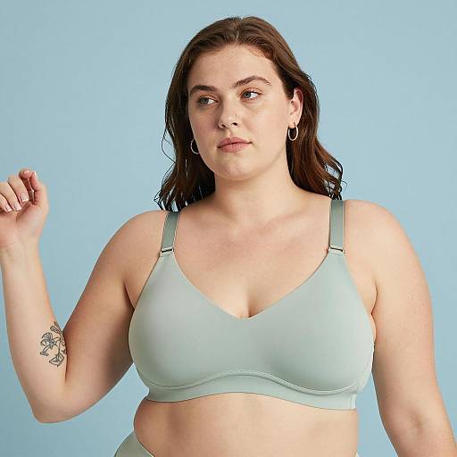 Curvy Woman in Light Green Bra Against Blue Background