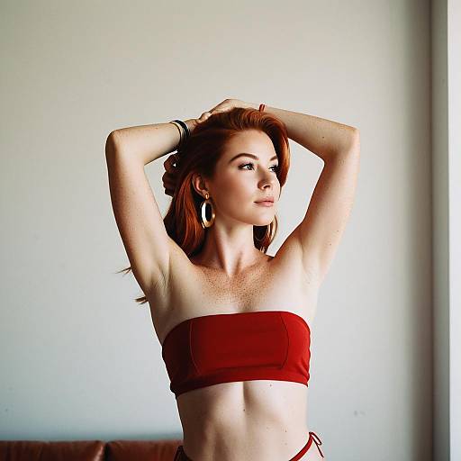 Woman in Red Bandeau Top with Statement Earrings