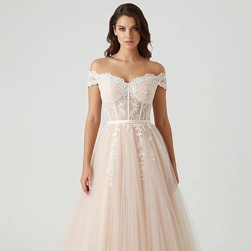 Photograph of a brunette woman with fair skin wearing an off-the-shoulder, white lace and tulle wedding dress, standing against a plain white