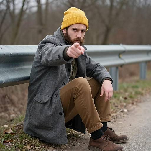 Man Sitting by Road Pointing Forward