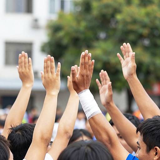 Hands Raised in Bright Outdoor Celebration