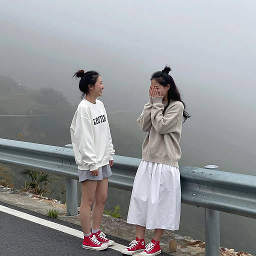 Two Women Laughing on Foggy Mountain Road