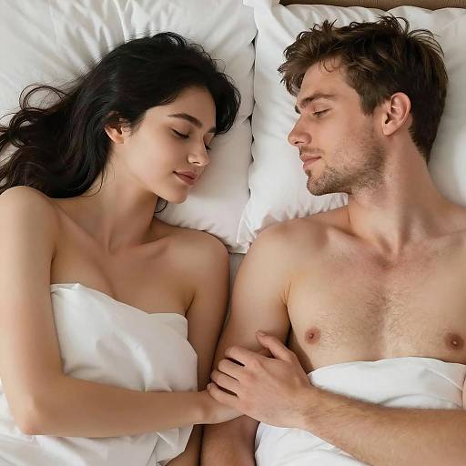 Couple Lying in Bed Holding Hands