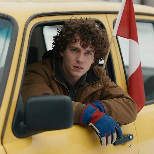 Focused Man in Yellow Car Window