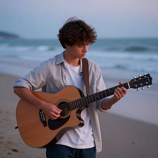 Teen Boy Playing Guitar on Beach