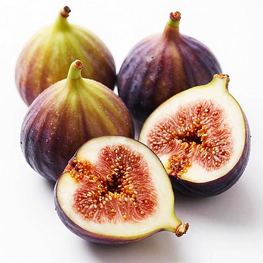 Photograph of three whole figs and two halved figs with vibrant purple skin, yellow-green stripes, and detailed red and white seedy interiors