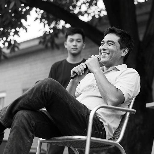 Smiling Man on Metal Chair in Sunlight