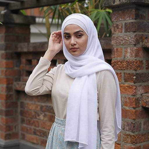 Young Woman Adjusting White Hijab