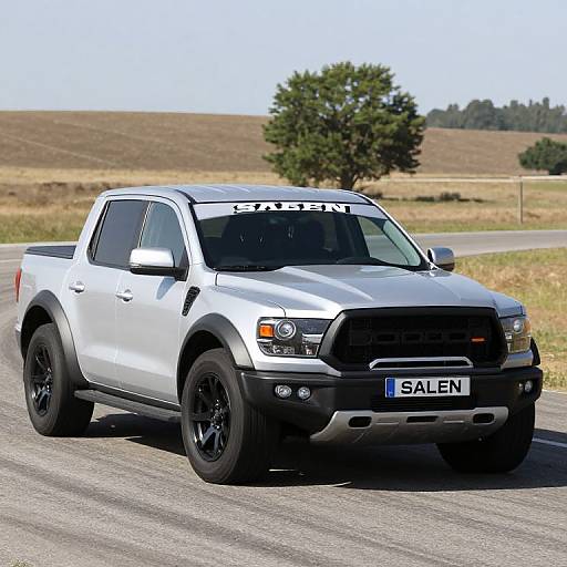 Photograph of a silver Ford F-150 pickup truck with black rims, 