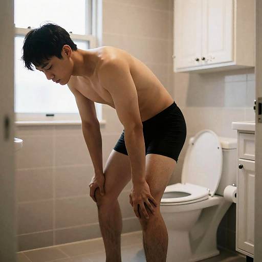 Shirtless Man in a Bright Bathroom Scene