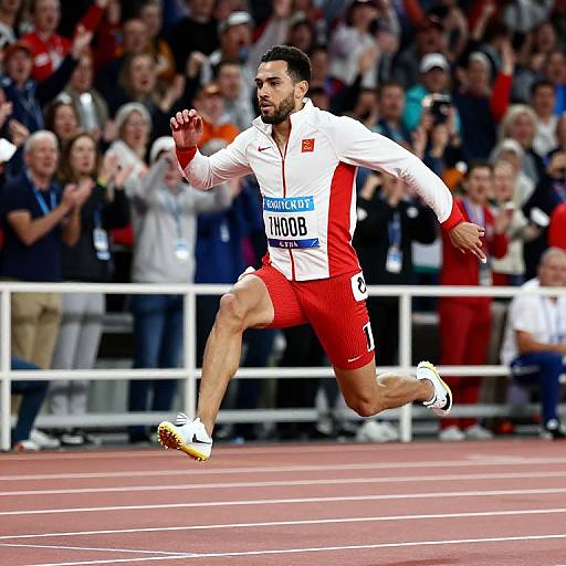 Photograph of a muscular male athlete with dark hair and beard, wearing a red and white track suit, mid-stride in a race, with a