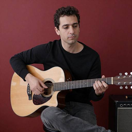 Acoustic Guitarist Against Red Wall