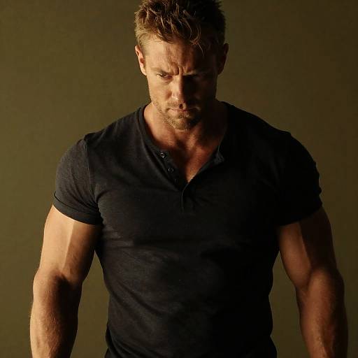 Muscular Man with Intense Expression in Dark Shirt