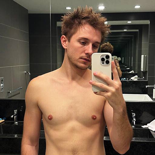 Man Taking Mirror Selfie in Modern Bathroom