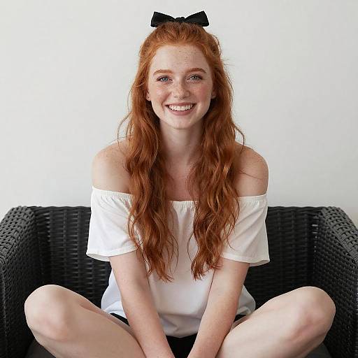 Smiling Redhead Woman on Wicker Couch