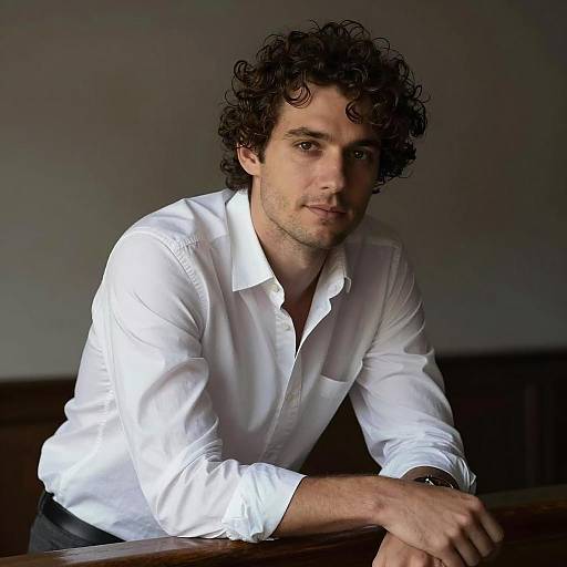 Man Leaning on Wooden Railing