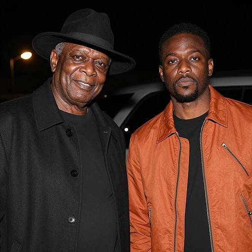 Two Black Men in Dimly Lit Setting