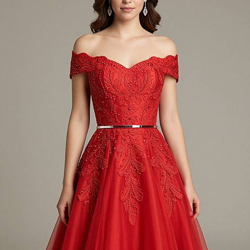 Photograph of a young woman in an off-the-shoulder, red, lace-embellished ball gown with a black belt, against a