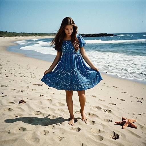 Girl in Blue Dress on Beach with Starfish