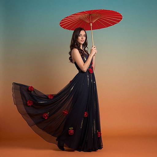 Photograph of a dark-haired woman in a flowing black dress with red rose accents, holding a red paper umbrella, standing against a gradient blue to orange