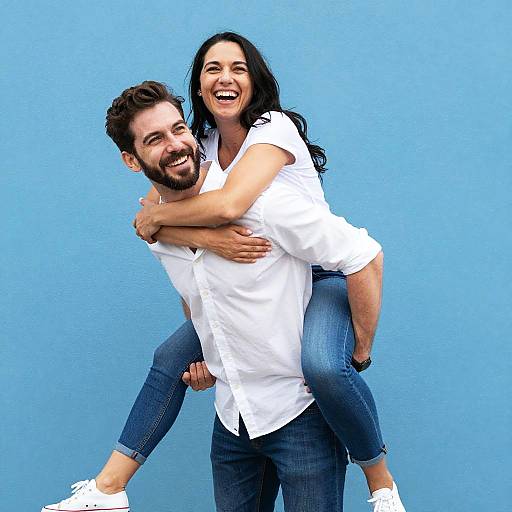 Joyful Piggyback Couple by Blue Wall