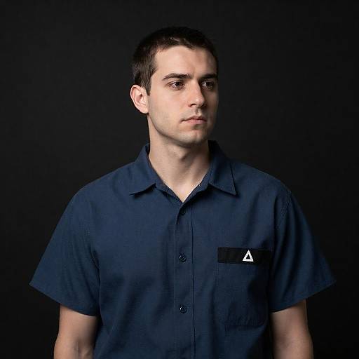 White man in dark blue prison shirt