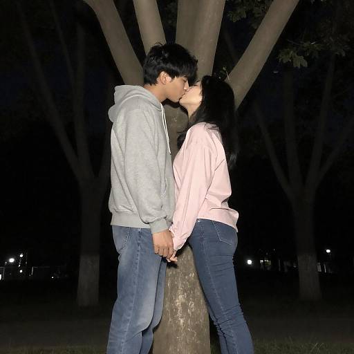 Romantic Nighttime Kiss Under Tree