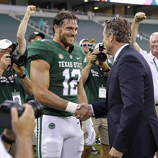 Texas State Football Player Shaking Hands with Coach