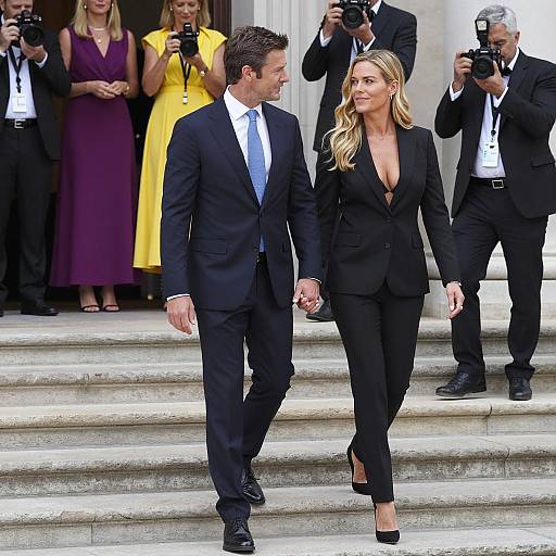 Couple Descending Steps with Photographers