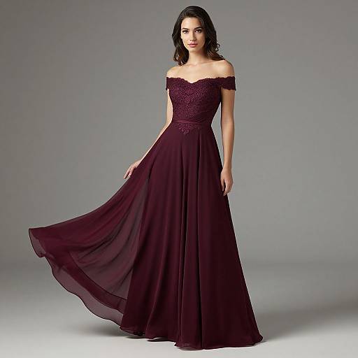 Photograph of a brunette woman in an off-the-shoulder, dark burgundy, lace-embellished, floor-length gown, standing against