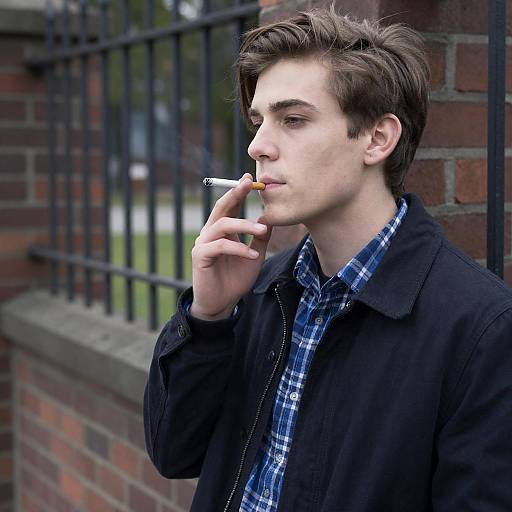 Young Man Smoking Cigarette Outdoors