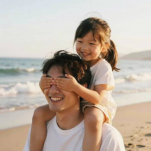 Happy Father and Daughter Playing on Beach