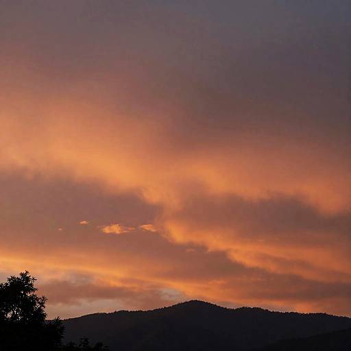 Crimson Sunset Over Mountainous Horizon