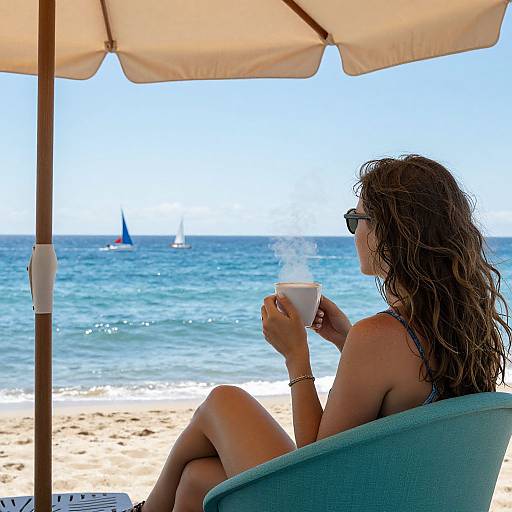 Woman Sipping Coffee by Ocean