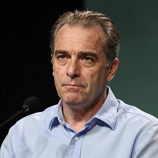 Middle-Aged Man Speaking at Microphone
