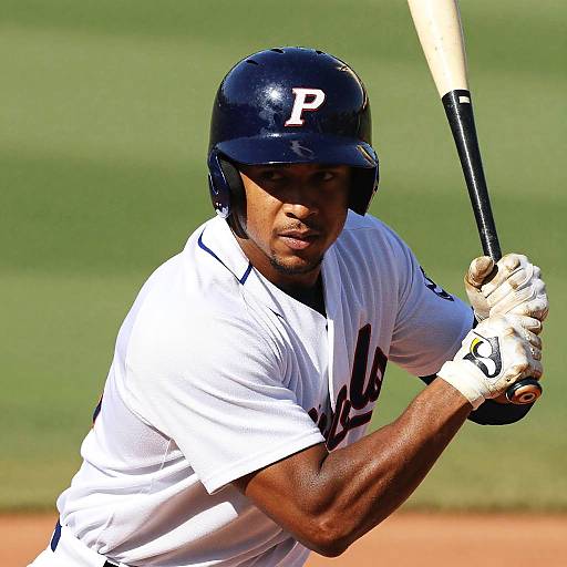 Photograph of a Black baseball player in a white uniform with 
