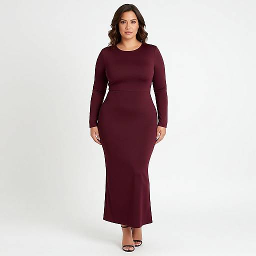 Photograph of a plus-size woman with medium skin tone and dark wavy hair, wearing a long-sleeve, deep burgundy dress and black
