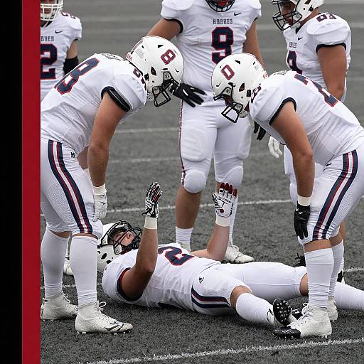 Football Team Aiding Injured Player