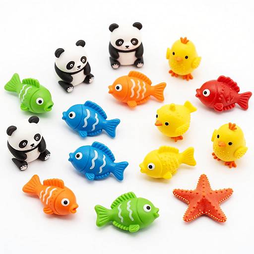 Photograph of colorful, plastic toy pandas and fish, including black-and-white pandas, orange, blue, green, yellow, and red fish, and