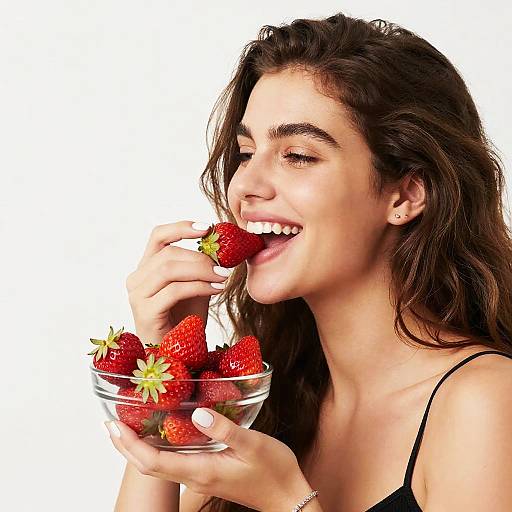 Cheerful Woman Enjoying Fresh Strawberries