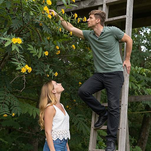 Couple Reaching for Yellow Flowers on Ladder in Forest