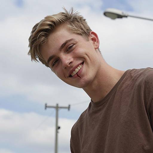 Young Man Smiling with a Blood Drop