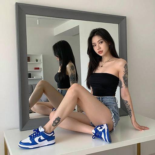 Tattooed Woman Sitting on Table