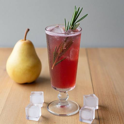 Photograph of a vibrant red cocktail in a glass, garnished with rosemary and ice, on a wooden table with ice cubes and a pear in