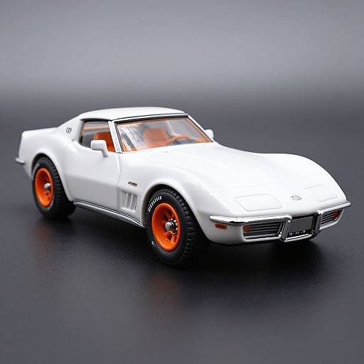 Photograph of a white toy car with orange wheels, sleek design, and black accents, positioned on a dark, reflective surface.