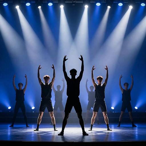 Silhouetted Dance Troupe in Blue Spotlight