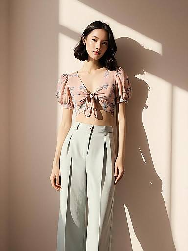Woman in Sheer Floral Cropped Blouse and High-Waisted Pants